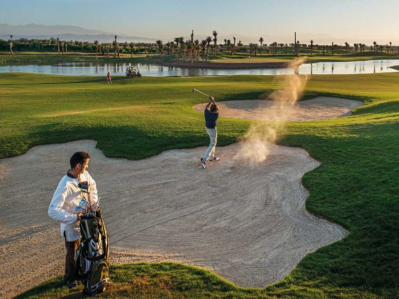 Golfeur sur le green et bunker